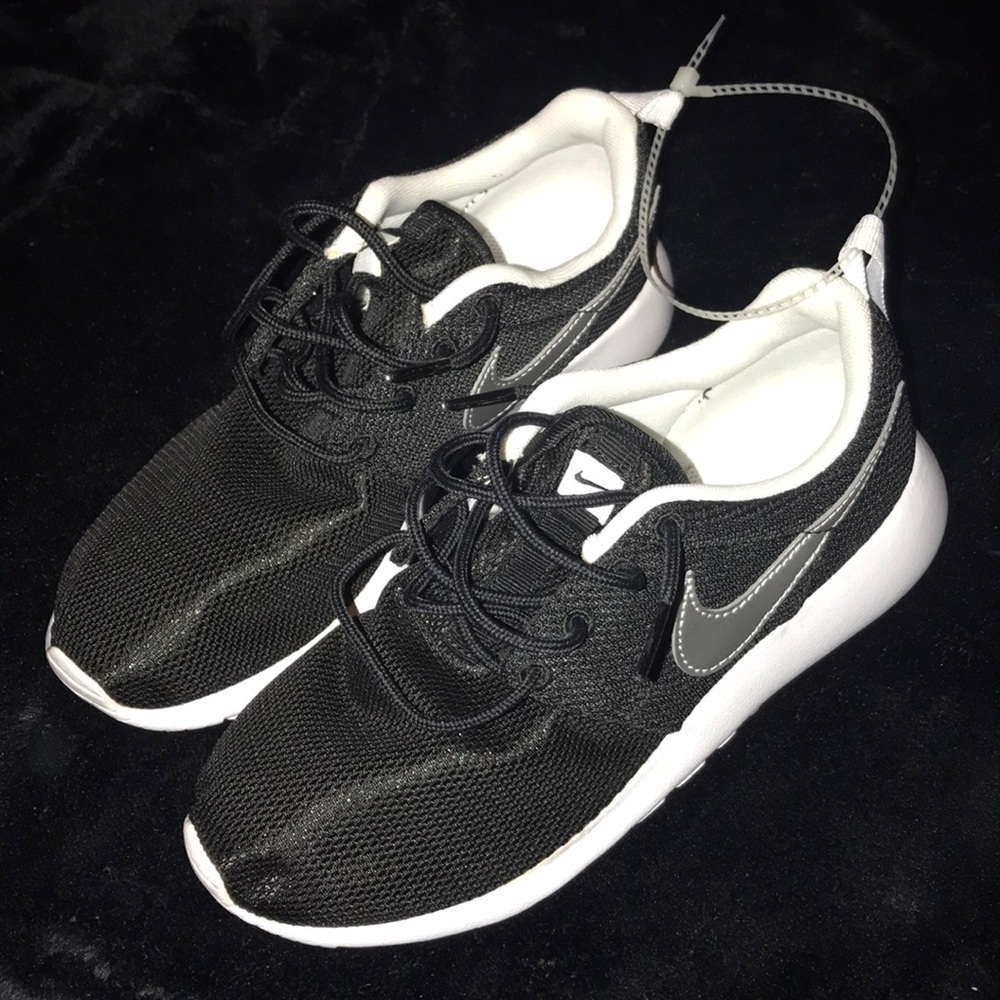Black Nike tennis shoes. 4 in youth, 6 in women’s.